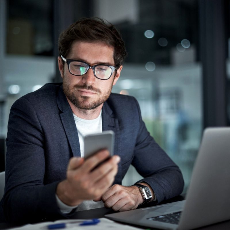 businessman-using-phone-and-laptop