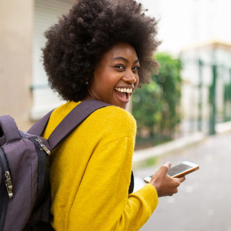 laughing-woman-wearing-backpack